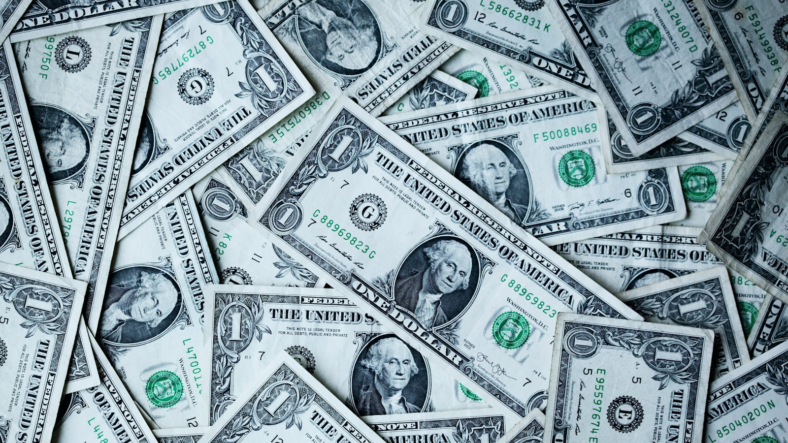 A pile of US dollar bills representing cash payouts from rewarded apps